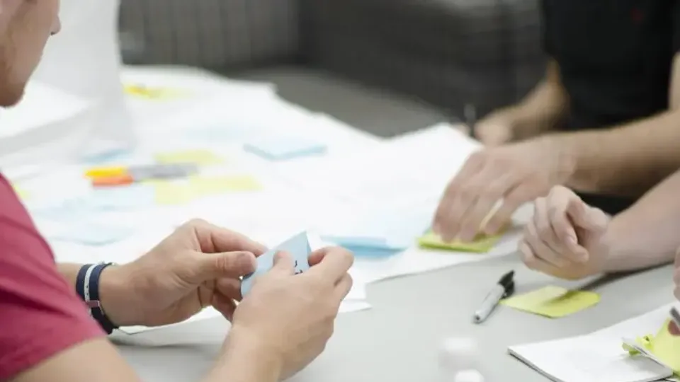 Team mapping a business workflow with sticky notes during a planning session